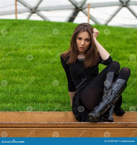 Young Beautiful Woman Sitting On A Bench In The Autumn Park Stock Image
