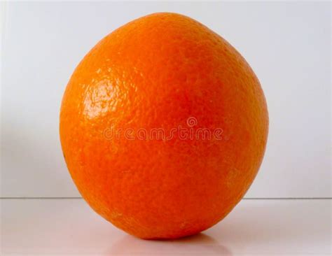 Isolated Whole Orange Closeup On White Flat Surface And Also White