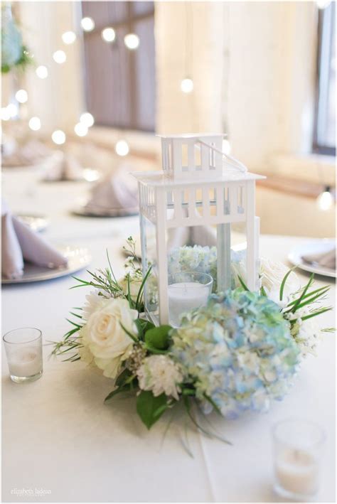 White Lantern Centerpieces With Blue Hydrangea With White Flowers