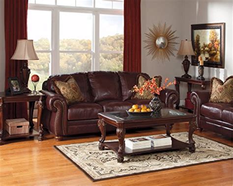 The norcastle oval coffee table deserves a toast for incorporating so many elements so seamlessly. Ashley Furniture Signature Design - Norcastle Coffee Table ...