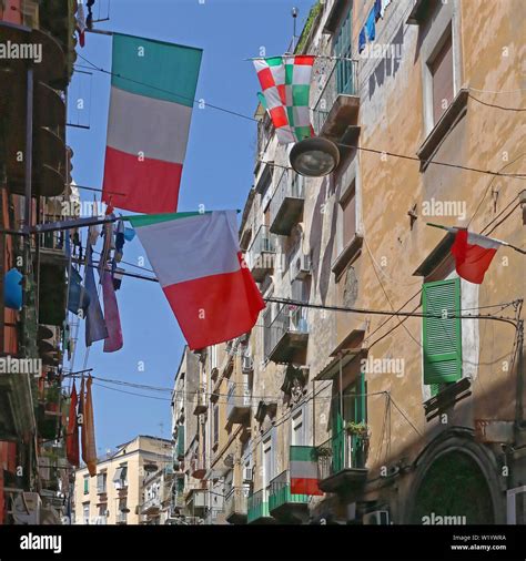 Italian And Napoli Flags At Narrow Street In Residential District Of