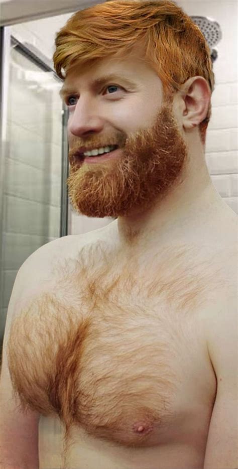 A Man With Red Hair And Beard Standing In Front Of A Bathroom Mirror Looking At The Camera