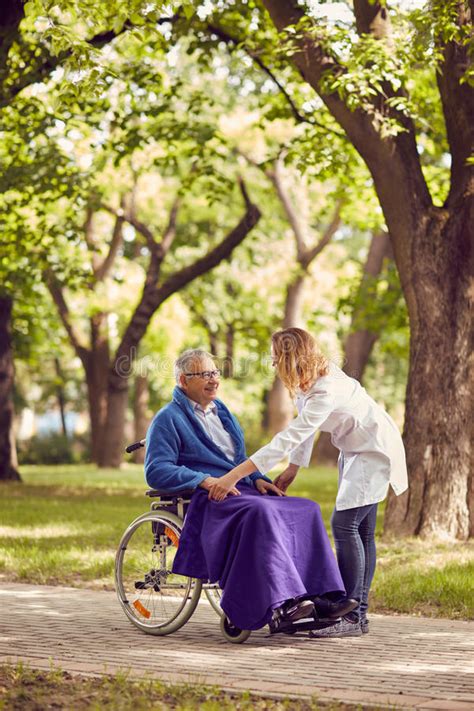 Nurse Helping Senior In Nature Stock Photo Image Of Health Hands