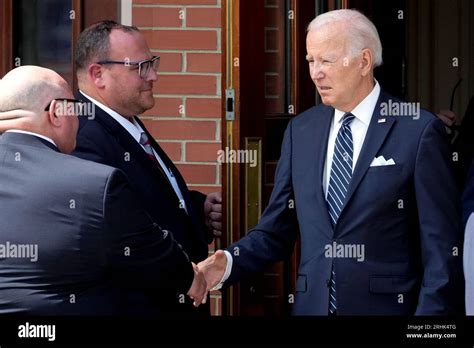 President Joe Biden greets people as he leaves after paying respects to