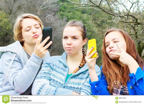 two girls doing selfies one alone stock image image of black selfie 68814903