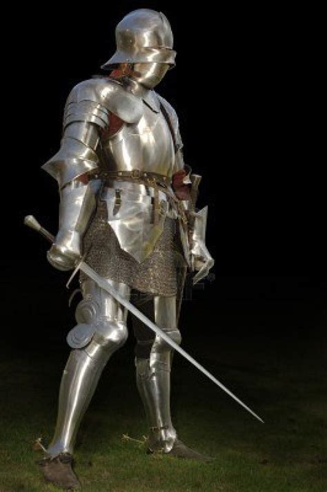 Medieval Knight In Shining Armour Of The 15th Century Standing Outside