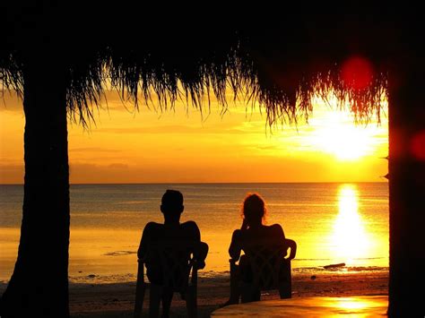 Sunset Silhouettes On The Beach Expediasummer Honeymoon Vacations