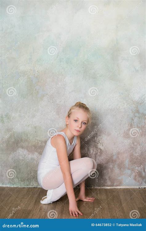 Little Ballet Dancer Doing Stretching Before Exercise Stock Photo