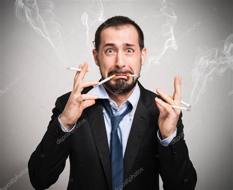 Nervous Man Smoking A Lot Of Cigarettes — Stock Photo © Minervastock