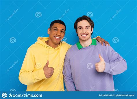 smiling interracial friends showing thumbs up stock image image of positive collar 220040363