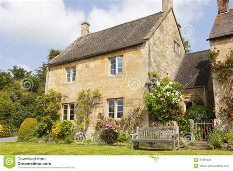 Charming English Cottage With Colorful Flowers In Front Garden Stock