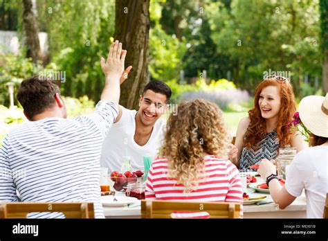 Smiling Group Of Young People Having Fun Laughing And Eating Healthy