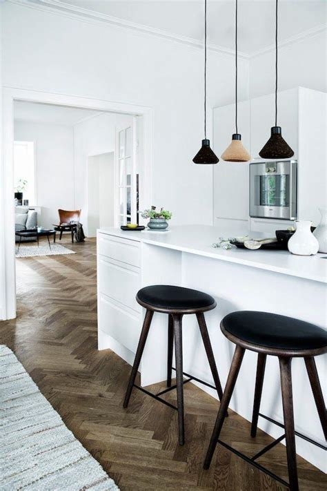 White Scandinavian Kitchen With Modern Black Accents And Bar Stools