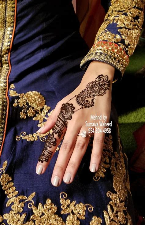 a woman s hand with henna on it