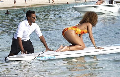 Rihanna Showcases Her Curves In A Flame Coloured Swimsuit As She Paddle