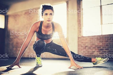 Sporty Woman Doing Stretching Exercise Before Workout In Gym Stockfoto