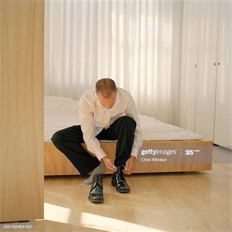 Man Putting On Shoes At Home Photos And Premium High Res Pictures