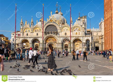 Tourists Are Walking Around The Basilica Di San Marco In Venice
