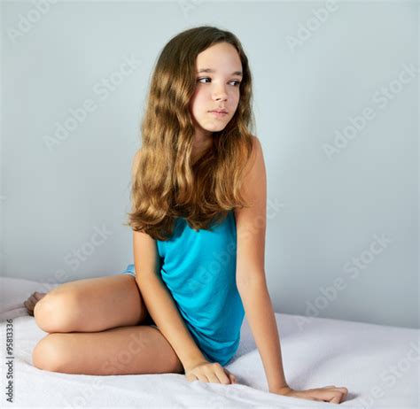 Sad Girl Sitting On The Bed And Looking Away Square Stock Photo And