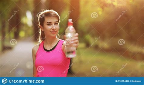Beautiful Fitness Athlete Runner Woman Drinking Water In The Park