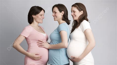 trio of pregnant women stand together looking at the belly of a grey background pregnant people