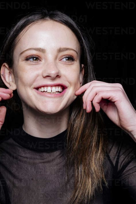 Smiling Caucasian Woman Pinching Cheek Stock Photo