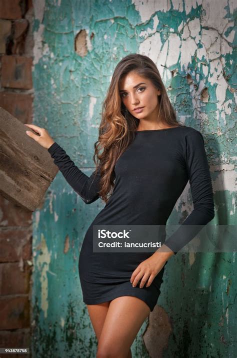 Young Lady With Short Black Mulled Skirt And Long Hair Posing