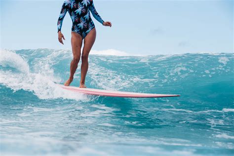A Woman On A Surfboard In The Ocean