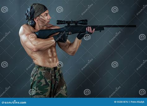Man Shoots From A Rifle Stock Photo Image Of Intense