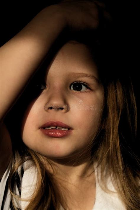 Dramatic Portrait Of Beautiful Sad Little Child Girl With Shadow On
