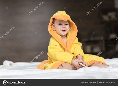 Baby Boy In Yellow Robe — Stock Photo © Lenamiloslavskaya 151079414