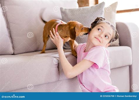 Portrait Of Attractive Cheery Funny Preteen Girl Playing With Doggy
