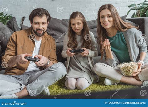 Father And Daughter Playing Video Game And Mother Stock Image Image