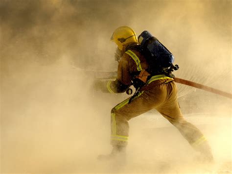 Download Firefighter In Smoky Operation Wallpaper