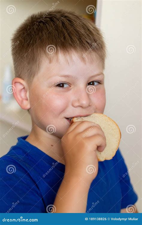 The Boy Is Happy To Eat Bread A Hungry Boy Stock Photo Image Of