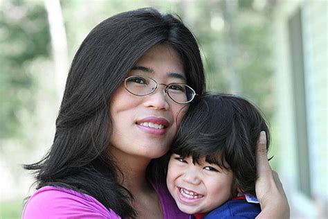 Asian Mother Lovingly Holding Her Son Hugging Handicap Disability Photo