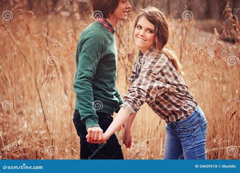 Happy Loving Couple On The Walk In Early Spring Field Stock Photo