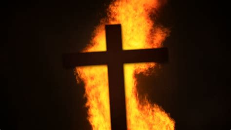 Burning Cross A Cross Bursts Into Flames On A Black Background Stock