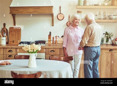 Happy Senior Wife Looking At Her Husband While Talking Together At