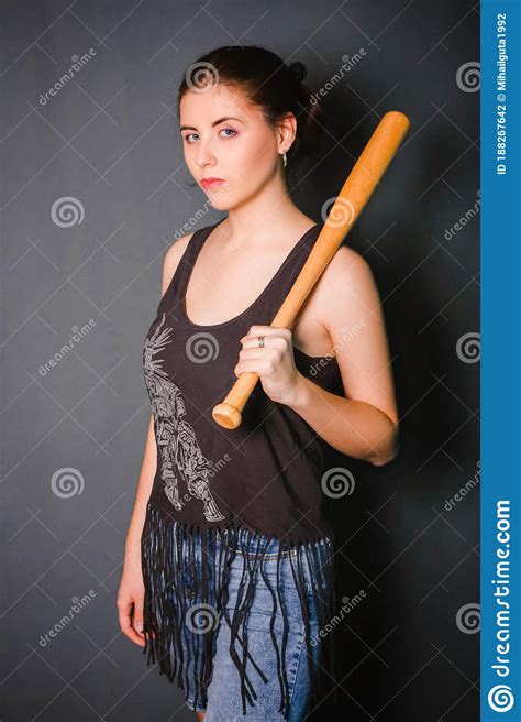 Young Beautiful Woman With A Baseball Bat In Her Hands Fashionable