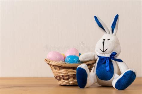 Easter Bunny Rabbit With Painted Egg On Wooden Background Stock Image
