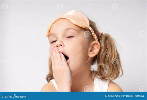 Portrait Of Yawning Little Girl In Sleaping Mask Sleep Concept Stock