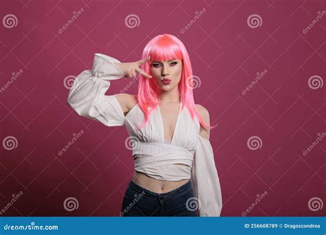Confident Pretty Woman With Pink Hair Doing Peace Sign And Kissy Face