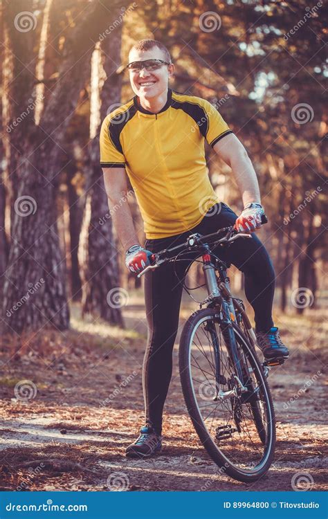 Man Cyclist Rides In The Forest On A Mountain Bike Stock Photo Image