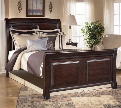 Deep finish brings warmth and elegance into the space. Signature Design by Ashley Furniture Ridgley King Sleigh ...