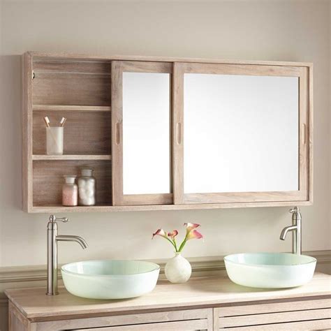 Two Sinks In Front Of A Wooden Cabinet With Mirrors Above Them And