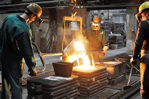 workers in a foundry casting a metal workpiece safety at work and teamwork stock image image