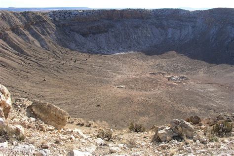 Meteor crater is located in desert with scarce vegetation cover. Meteor Crater, AZ- The Enigmas on Earth