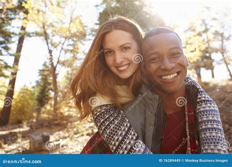 happy mixed race couple embracing during hike in a forest stock image image of diversity copy