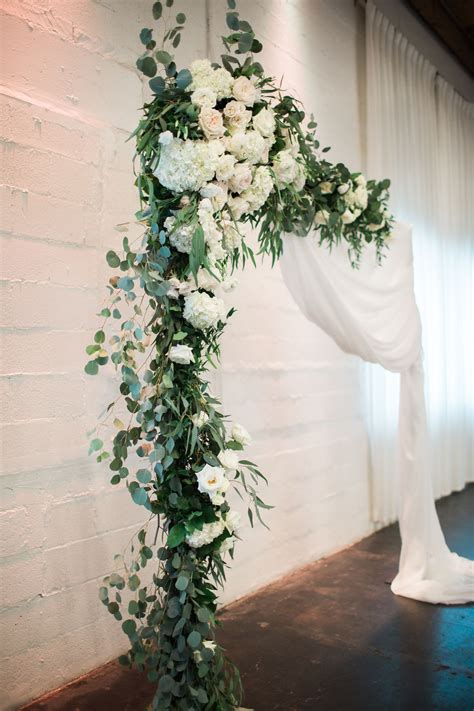 If you're trying to save on wedding flowers, think about using some bouquets at both the wedding ceremony and the reception. Ceremony Square Arch | White floral arrangements, Ceremony ...